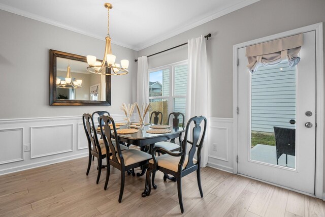 6787 Dharma Loop, Chattanooga, TN 37412 - dining area featuring a chandelier, crown molding, wainscoting, light wood finished floors, and a decorative wall