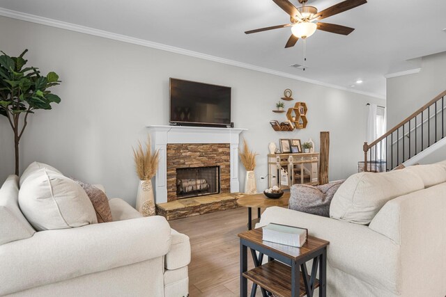 6787 Dharma Loop, Chattanooga, TN 37412 - living area with crown molding, a ceiling fan, wood finished floors, stairs, and a stone fireplace
