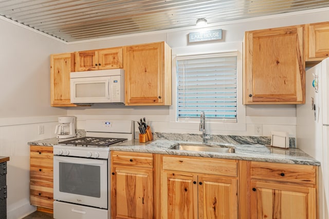 4053 Deer Creek Rd, Linden, TN 37096 - kitchen with white appliances, a sink, wainscoting, light stone countertops, and light brown cabinetry