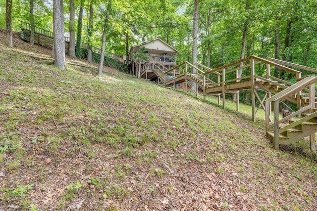 4053 Deer Creek Rd, Linden, TN 37096 - view of yard featuring stairs, a deck, and view of wooded area