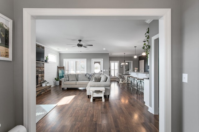 2466 Cason Ln, Murfreesboro, TN 37128 - living area featuring dark wood-style flooring, a fireplace, a ceiling fan, plenty of natural light, and crown molding