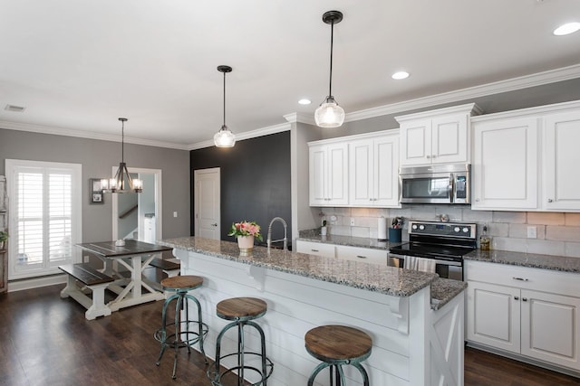 2466 Cason Ln, Murfreesboro, TN 37128 - kitchen featuring stainless steel microwave, electric range, decorative backsplash, white cabinets, and ornamental molding