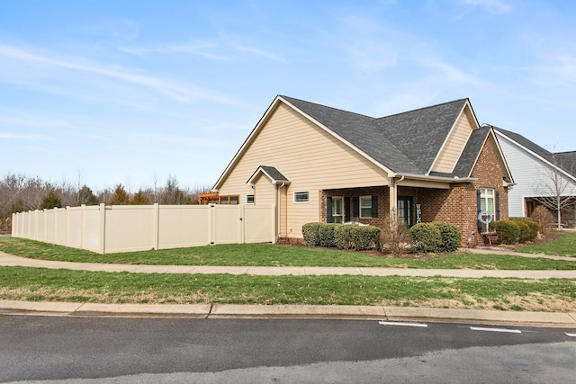 2466 Cason Ln, Murfreesboro, TN 37128 - view of home's exterior with a gate, brick siding, and roof with shingles