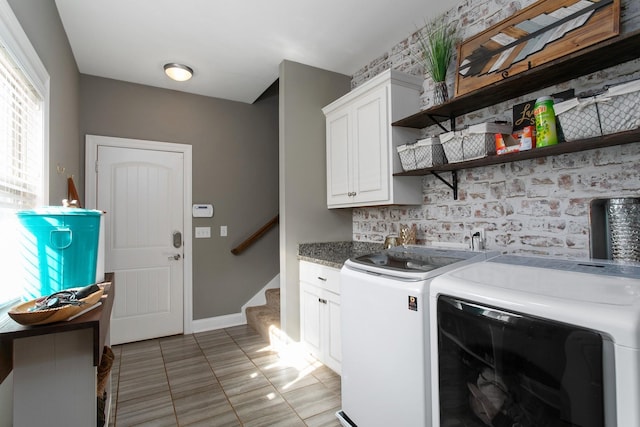 2466 Cason Ln, Murfreesboro, TN 37128 - laundry room with cabinet space, washer and clothes dryer, light tile patterned floors, and baseboards