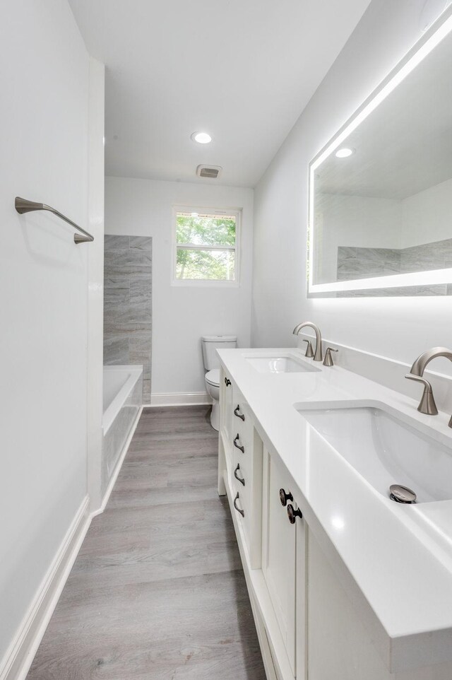 117 Apollo Ct W, Antioch, TN 37013 - full bath with double vanity, toilet, a tub, recessed lighting, and baseboards