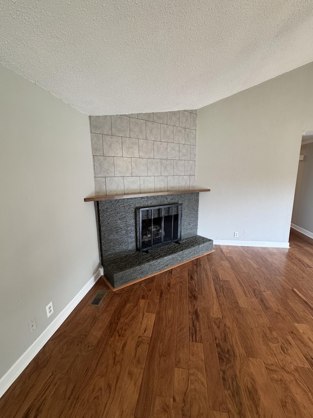 2306 Raspberry Ln, Lebanon, TN 37087 - detailed view of a fireplace, wood finished floors, a textured ceiling, and baseboards