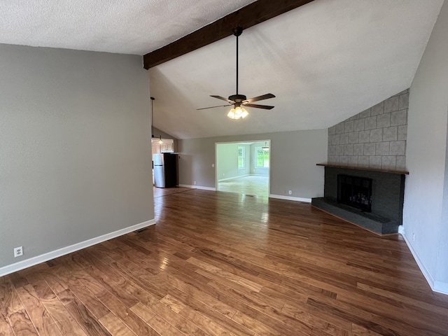 2306 Raspberry Ln, Lebanon, TN 37087 - unfurnished living room with a large fireplace, a ceiling fan, wood finished floors, baseboards, and a textured ceiling