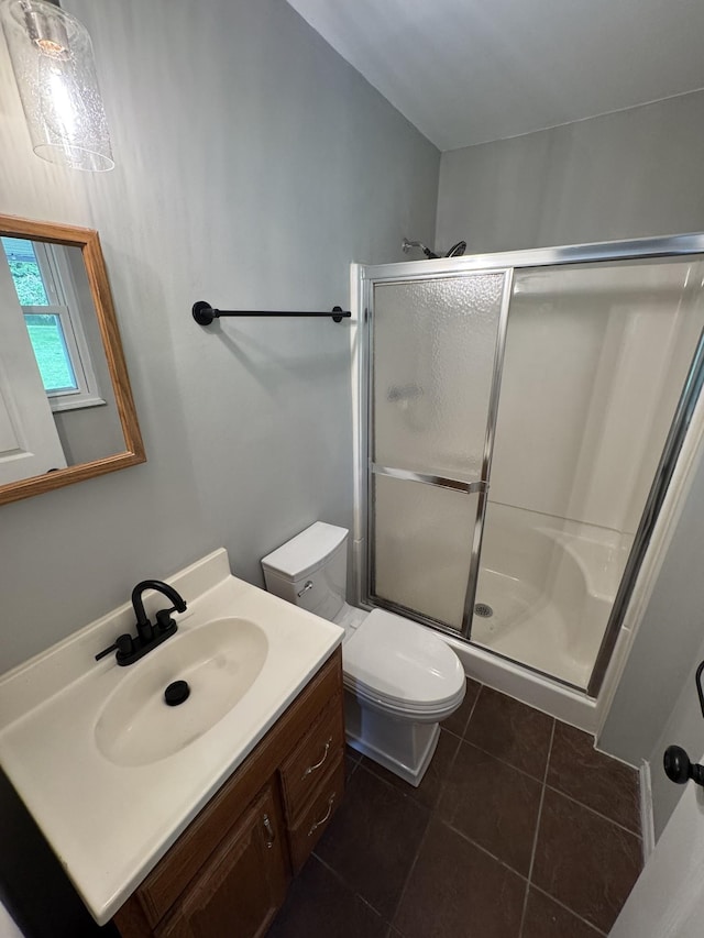2306 Raspberry Ln, Lebanon, TN 37087 - bathroom featuring a stall shower, vanity, toilet, and tile patterned floors