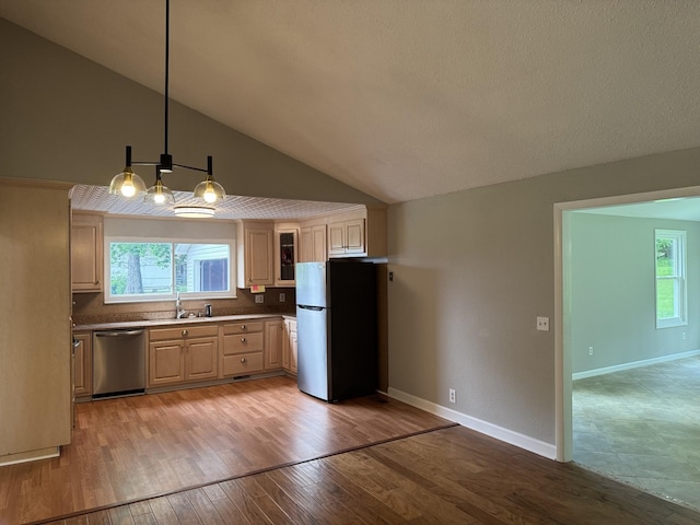 2306 Raspberry Ln, Lebanon, TN 37087 - kitchen featuring appliances with stainless steel finishes, plenty of natural light, light brown cabinets, a sink, and high vaulted ceiling