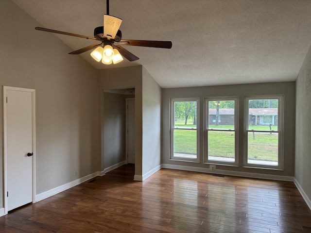 2306 Raspberry Ln, Lebanon, TN 37087 - empty room featuring lofted ceiling, a textured ceiling, wood finished floors, and baseboards