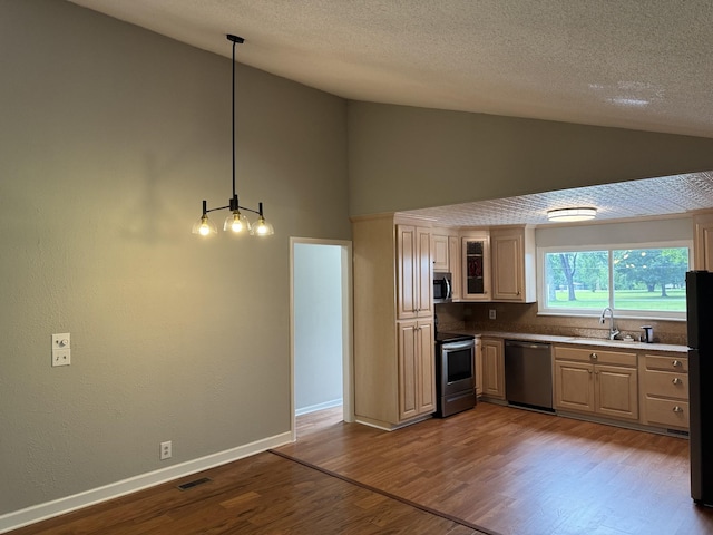 2306 Raspberry Ln, Lebanon, TN 37087 - kitchen with appliances with stainless steel finishes, dark wood-style floors, high vaulted ceiling, a sink, and pendant lighting