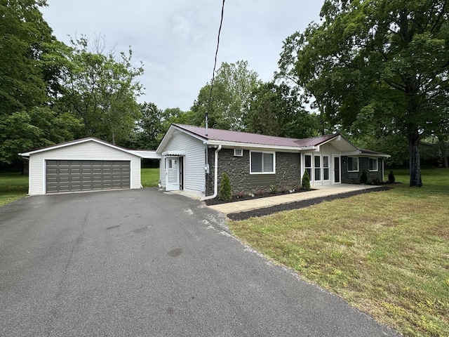 2306 Raspberry Ln, Lebanon, TN 37087 - ranch-style home featuring a detached garage, stone siding, an outbuilding, a front lawn, and metal roof