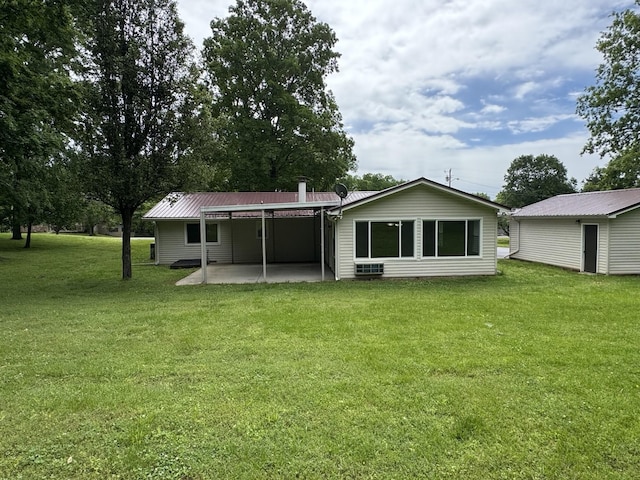 2306 Raspberry Ln, Lebanon, TN 37087 - back of property with a lawn, a patio, a carport, and metal roof