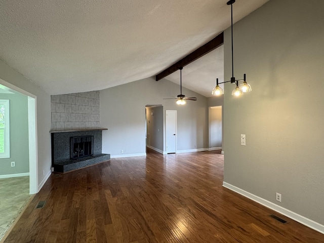 2306 Raspberry Ln, Lebanon, TN 37087 - unfurnished living room with a tile fireplace, dark wood finished floors, a textured ceiling, a ceiling fan, and baseboards