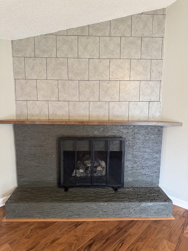2306 Raspberry Ln, Lebanon, TN 37087 - detailed view of a large fireplace, wood finished floors, and baseboards