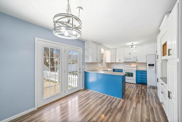421 Bancroft Dr, Clarksville, TN 37042 - kitchen featuring white appliances, a chandelier, backsplash, dark wood-type flooring, and a peninsula