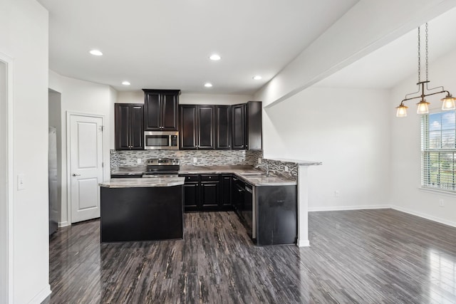 2003 Allerton Way, Spring Hill, TN 37174 - kitchen featuring appliances with stainless steel finishes, dark wood-style floors, backsplash, light countertops, and recessed lighting