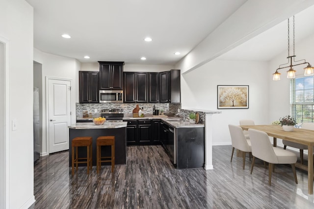2003 Allerton Way, Spring Hill, TN 37174 - kitchen with appliances with stainless steel finishes, backsplash, light countertops, dark wood-style floors, and recessed lighting