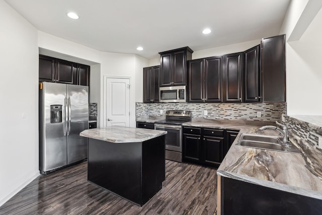 2003 Allerton Way, Spring Hill, TN 37174 - kitchen with stainless steel appliances, a sink, dark wood-style floors, decorative backsplash, and recessed lighting