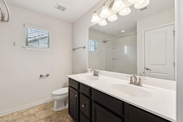 2003 Allerton Way, Spring Hill, TN 37174 - bathroom featuring baseboards, a shower, toilet, and double vanity
