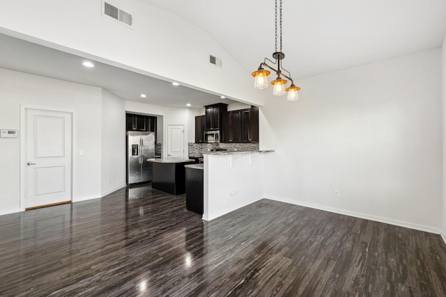 2003 Allerton Way, Spring Hill, TN 37174 - kitchen featuring appliances with stainless steel finishes, dark wood-style flooring, lofted ceiling, open floor plan, and a peninsula