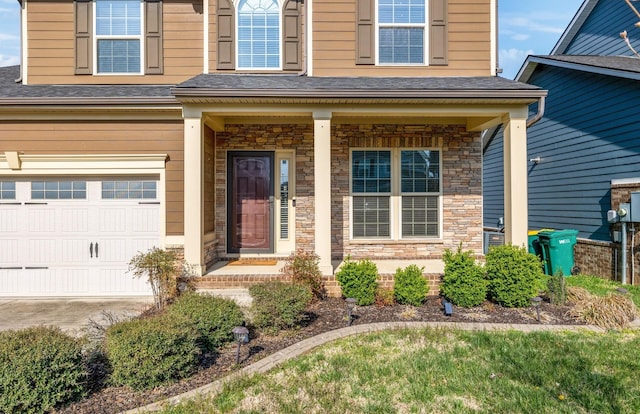 2003 Allerton Way, Spring Hill, TN 37174 - doorway to property with stone siding, an attached garage, concrete driveway, and roof with shingles