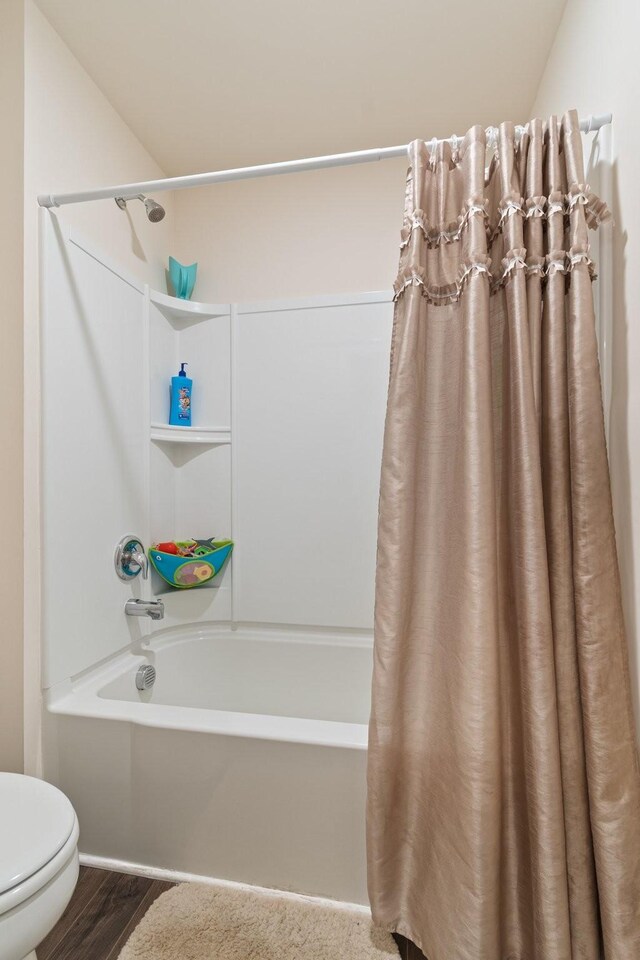 2555 Queen Bee Dr, Columbia, TN 38401 - bathroom featuring shower / tub combo with curtain and wood finished floors