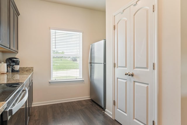 2555 Queen Bee Dr, Columbia, TN 38401 - kitchen featuring appliances with stainless steel finishes, dark wood finished floors, and light stone counters