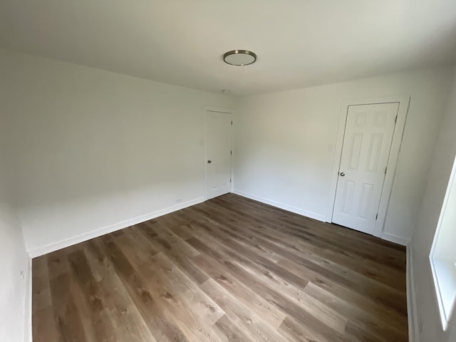 119 Maple Ave, Camden, TN 38320 - spare room featuring dark wood-style flooring and baseboards