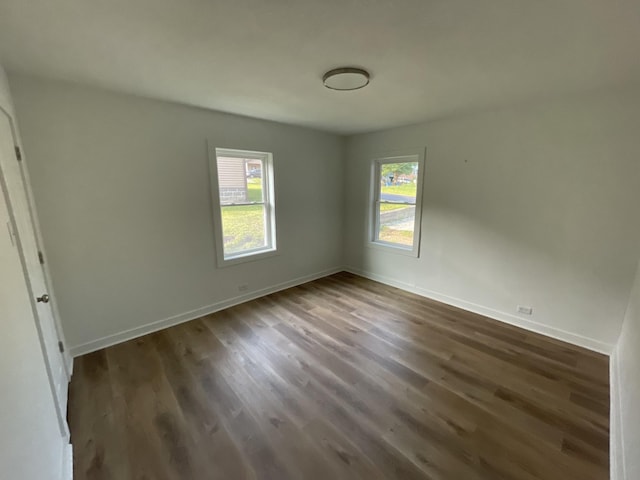 119 Maple Ave, Camden, TN 38320 - spare room featuring healthy amount of natural light, dark wood-style flooring, and baseboards