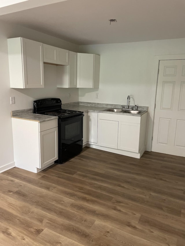 119 Maple Ave, Camden, TN 38320 - kitchen with black electric range oven, a sink, white cabinets, and dark wood-style flooring