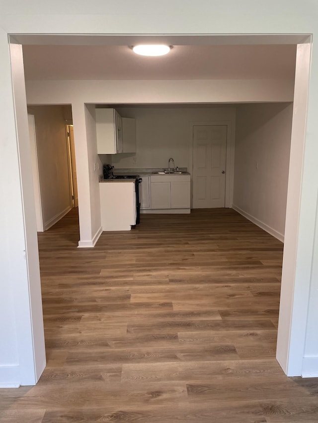 119 Maple Ave, Camden, TN 38320 - kitchen featuring range, baseboards, a sink, and wood finished floors