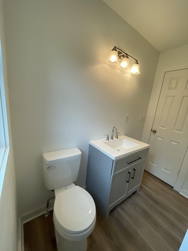 119 Maple Ave, Camden, TN 38320 - half bathroom featuring wood finished floors, toilet, and vanity