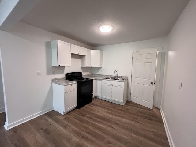 119 Maple Ave, Camden, TN 38320 - kitchen with black electric range, white cabinets, dark wood-style flooring, and light countertops