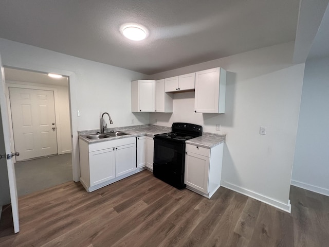 119 Maple Ave, Camden, TN 38320 - kitchen featuring black electric range oven, dark wood-type flooring, white cabinets, and light countertops