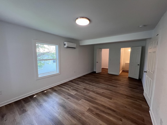 119 Maple Ave, Camden, TN 38320 - unfurnished bedroom with a wall mounted air conditioner and dark wood-style floors