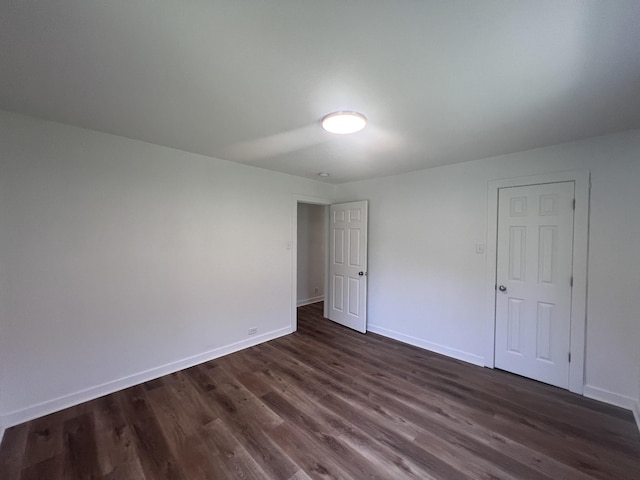 119 Maple Ave, Camden, TN 38320 - unfurnished bedroom featuring dark wood-style floors and baseboards