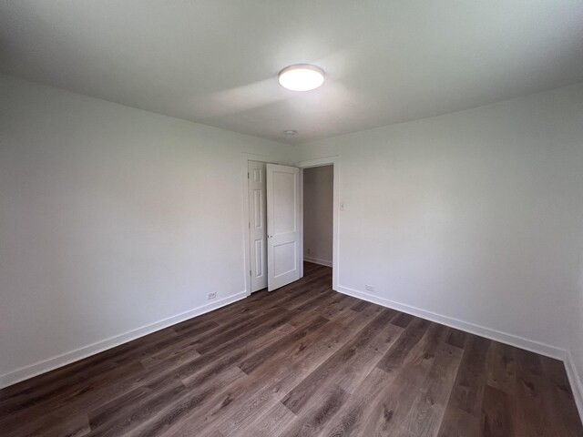 119 Maple Ave, Camden, TN 38320 - empty room with dark wood-type flooring and baseboards