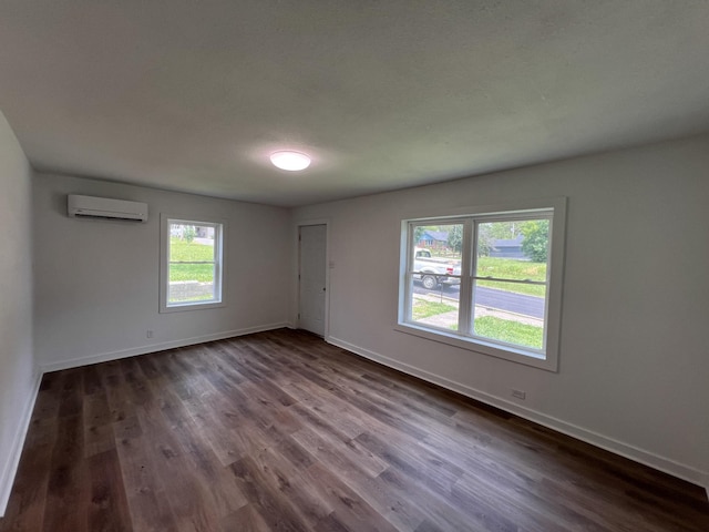 119 Maple Ave, Camden, TN 38320 - unfurnished room featuring a wall mounted air conditioner and dark wood-style flooring