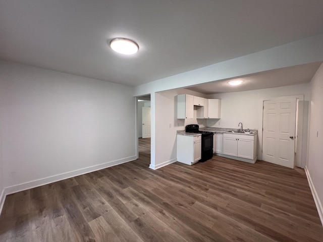 119 Maple Ave, Camden, TN 38320 - kitchen featuring gas stove, dark wood-style flooring, white cabinets, light countertops, and open floor plan