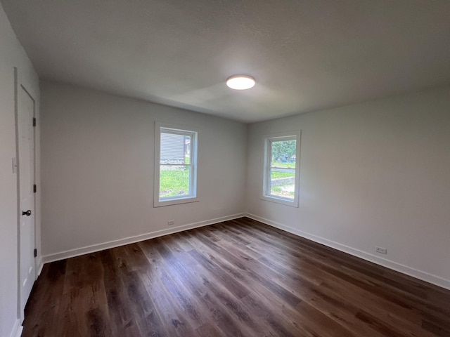 119 Maple Ave, Camden, TN 38320 - unfurnished room featuring dark wood-style flooring and baseboards