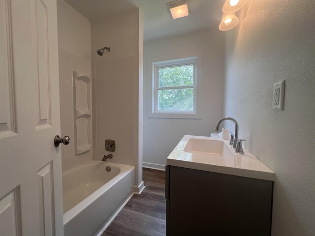 119 Maple Ave, Camden, TN 38320 - full bath with vanity, wood finished floors, and washtub / shower combination