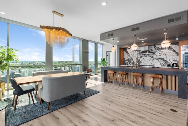 900 20th Ave S Unit 1601, Nashville, TN 37212 - dining area featuring a wall of windows, light wood-style floors, and a community bar