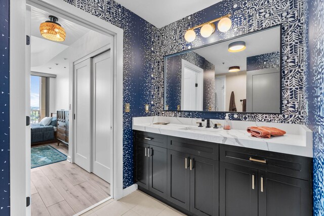 900 20th Ave S Unit 1601, Nashville, TN 37212 - full bathroom with wallpapered walls, vanity, ensuite bathroom, and baseboards