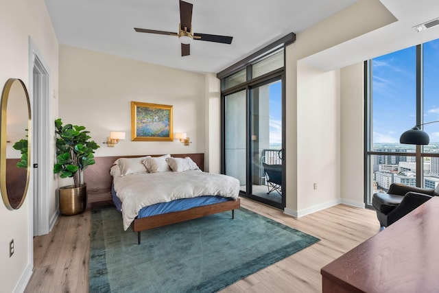 900 20th Ave S Unit 1601, Nashville, TN 37212 - bedroom featuring a wall of windows, access to exterior, light wood-type flooring, baseboards, and ceiling fan