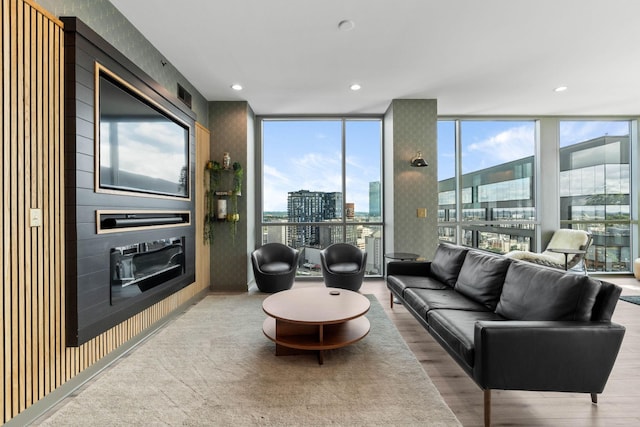 900 20th Ave S Unit 1601, Nashville, TN 37212 - living area featuring a wall of windows, wood finished floors, recessed lighting, and a large fireplace