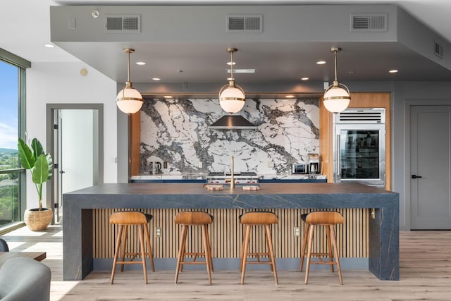 900 20th Ave S Unit 1601, Nashville, TN 37212 - indoor wet bar featuring light wood-style floors, a wall of windows, recessed lighting, and hanging light fixtures