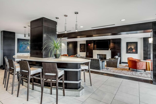 900 20th Ave S Unit 1601, Nashville, TN 37212 - kitchen with a fireplace, light countertops, light tile patterned floors, pendant lighting, and recessed lighting