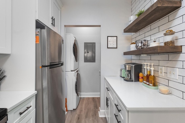 7234 Althorp Way Unit U8, Nashville, TN 37211 - kitchen with freestanding refrigerator, stacked washer / drying machine, open shelves, electric panel, and backsplash