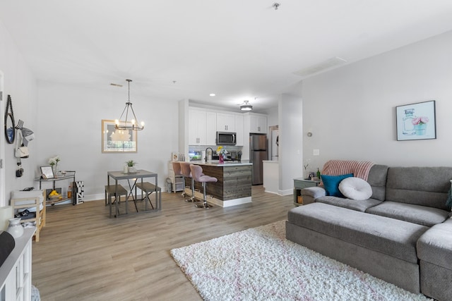 7234 Althorp Way Unit U8, Nashville, TN 37211 - living room with light wood-type flooring, a chandelier, baseboards, and recessed lighting
